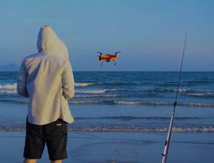 guy flying drone for fishing